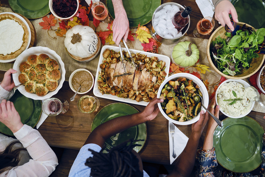 Dinner table set with holiday foods.