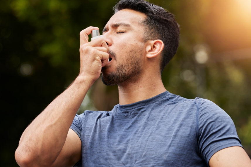 A man uses his inhaler.