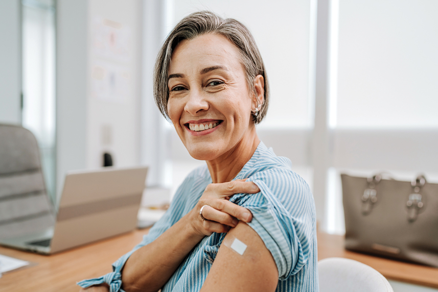 Woman smiling after getting a vaccine