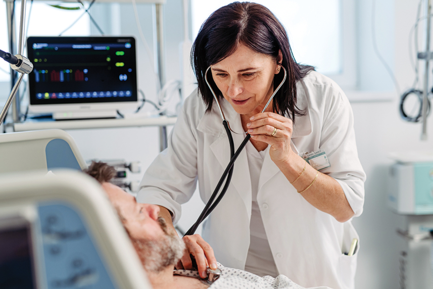Doctor using stethoscope on man