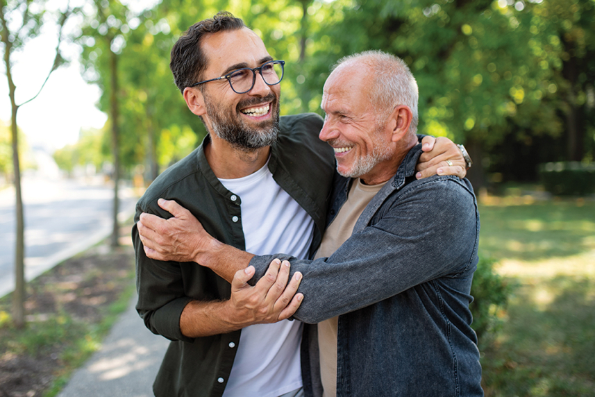 Father and adult son hugging
