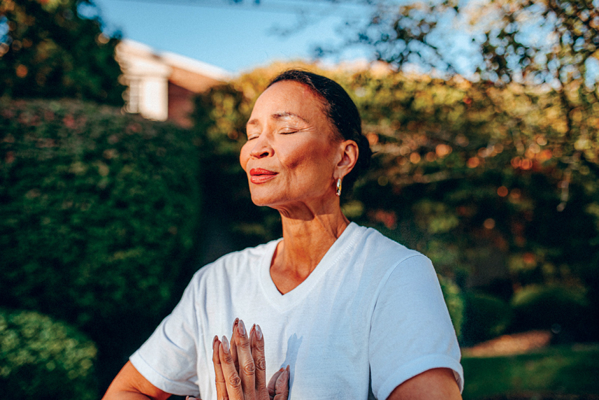 Woman meditating outside. 