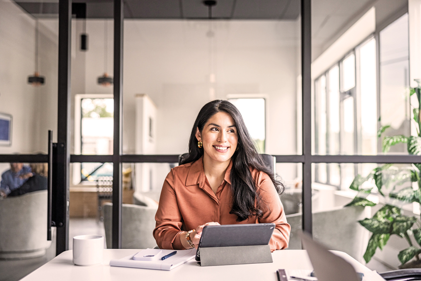 Woman on tablet in her office
