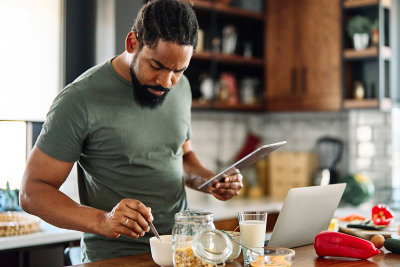 A man meal planning in a kitchen
