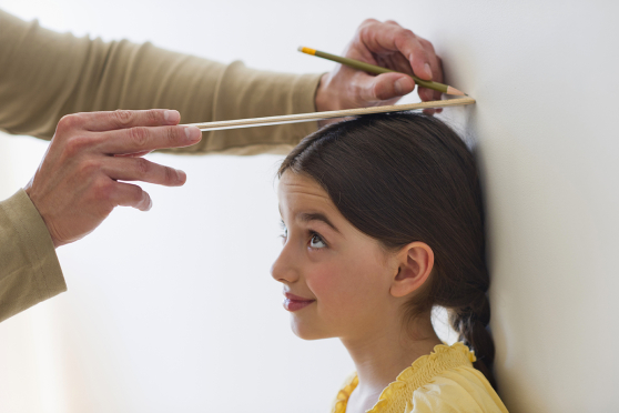 Girl getting her height measured.