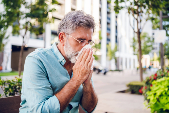 Man blowing his nose.