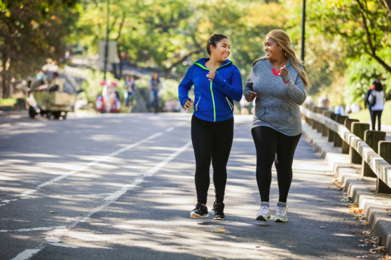 Two women speed walking.