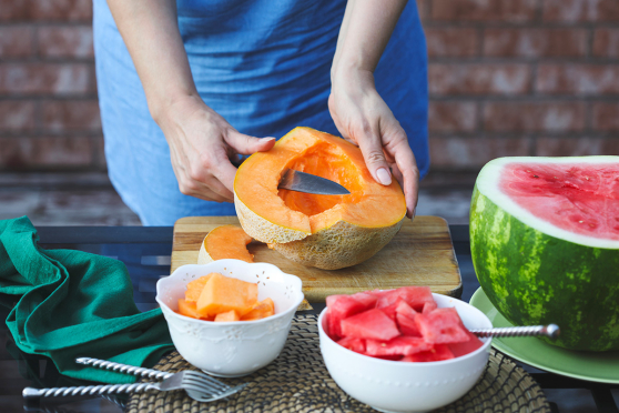 Woman cutting melons