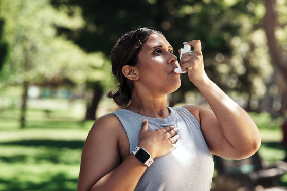Woman using an inhaler