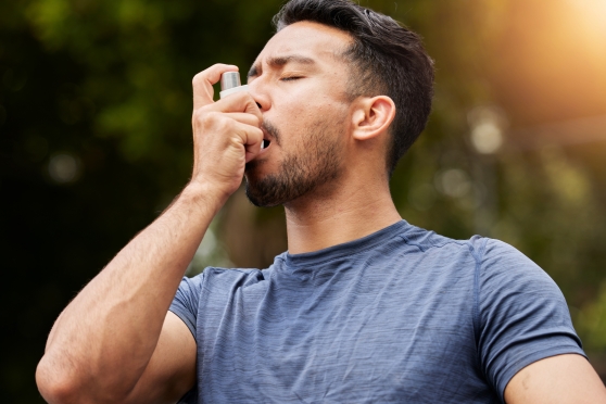 A man uses his inhaler.