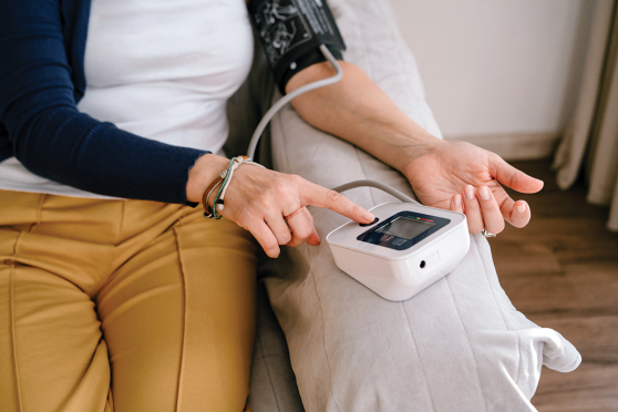 A woman takes her blood pressure