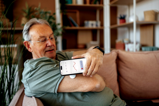 Man using a continuous glucose monitor. 